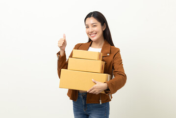 Young excited beautiful asian woman with many parcel cardboard standing on isolated white background. Cheerful female holding lot of parcel box receive from the delivery service