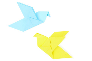 Blue and yellow paper birds isolated on white background