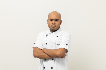 Irritable Young handsome asian man chef in uniform standing angry emotional Unhappy annoyed on...