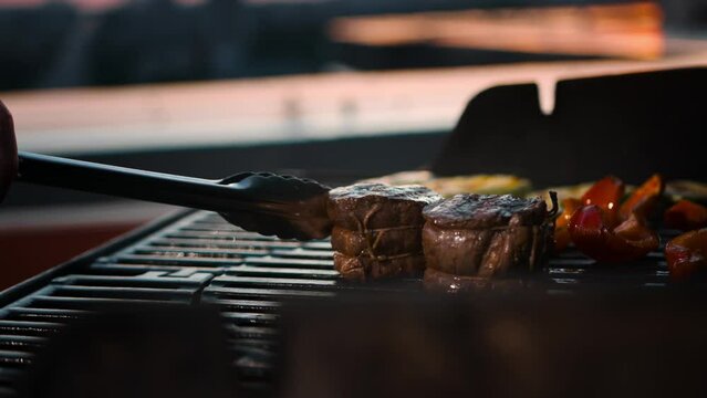BBQ close-up: filet mignon steak and grilled vegetables cooking