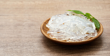 clear kelp or seaweed noodle in a wooden plate on wooden background. glass noodle                  ...