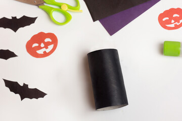 Step by step photo instruction Halloween craft. Step 2 Handmade decoration cat from toilet paper roll. Reuse concept