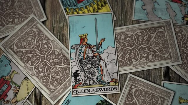 Los Angels, USA - January 30, 2021: Tarot Cards Falling. The Queen Of Swords On Stone Throne. Independent Judgement And Direct Communication. Emotional And Cold-Hearted. Divination. Fortune Reading.