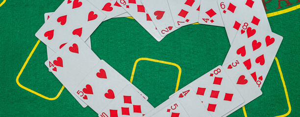 chip cards laid out in the shape of a heart on a green poker table.