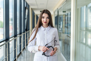 Fototapeta na wymiar a portrait of a girl nurse alone who is standing beautifully in the hospital.