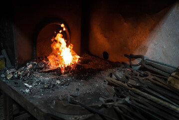 Close up view of heated metal and fire oven. Blacksmith in the production process of other metal...