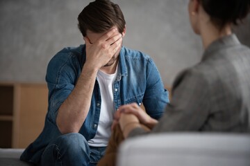 Psychologist talking with patient on therapy session.