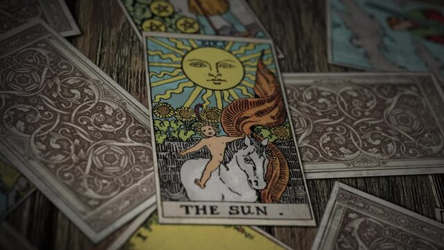 Berlin, Germany - June 20, 2014. Using magic tarot card for fortune prediction. A Psychic is reading Magic Card The Sun for fortune prediction. Magically predicting people's fortune with tarot cards.