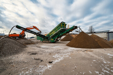 Mobile crushing and sorting complex works among soil piles