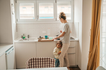 Daughter and mother standing in the kitchen