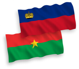 National vector fabric wave flags of Liechtenstein and Burkina Faso isolated on white background. 1 to 2 proportion.