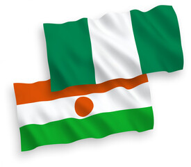 Fototapeta premium National vector fabric wave flags of Republic of the Niger and Nigeria isolated on white background. 1 to 2 proportion.