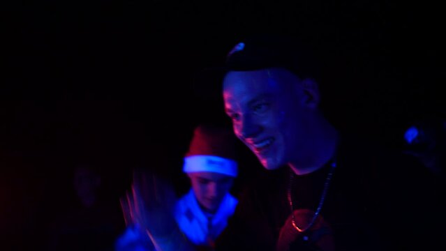 Australian Street Gabber Dancing In An Illegal Rave Party At Night. close up