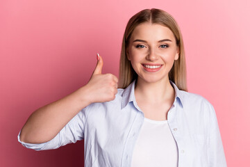 Photo of young girl show thumb-up approve ideal suggest advertise isolated over pink color background