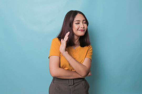 Stop. Concerned Asian Woman Showing Refusal Sign, Saying No, Raise Awareness, Standing Over Blue Background