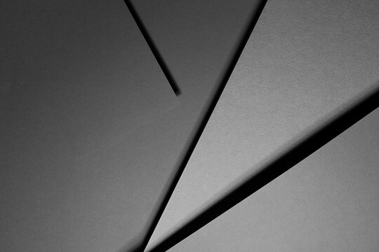 Carbon grey abstract geometric background with fly rectangle surfaces, stripes, corners, lines in hard light, shadows in rich minimal business style for card, poster, flyer, text, top view.