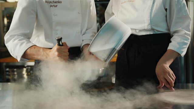 Professional kitchen: liquid nitrogen is added during the cooking of a molecular dish