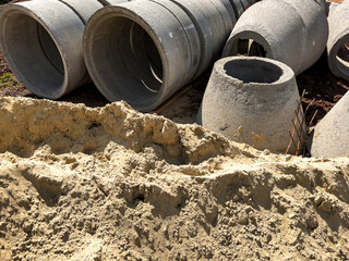 Concrete sewer pipes on building construction site