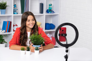 Teenager recording online media video. Teen girl streaming online and sharing social media content by mobile phone app network. Happy girl face, positive and smiling emotions.