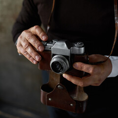Cropped image of elderly man with old photo camera