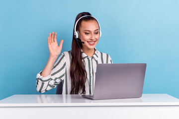 Friendly female helpline operator sit desk connection client via web chatting hello hi isolated...