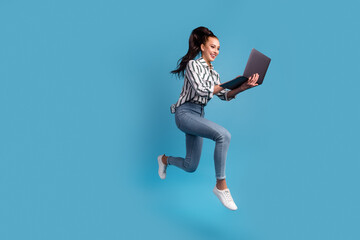 Fototapeta na wymiar Photo of pretty charming woman using device jumping running isolated blue color background