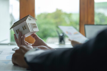 Young man signing financial contract with real estate agent.