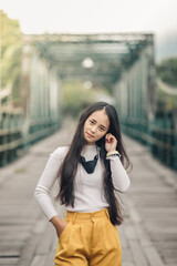 young asian woman Smile and sit down smile in Pai Memorial Bridge