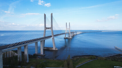 Lisboa, Portugal, April 24, 2022: Aerial view of the Vasco da Gama Bridge is a cable-stayed bridge...