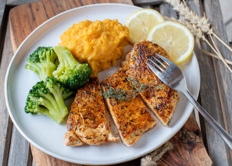 Turkey breast with pumpkin puree and broccoli on a plate