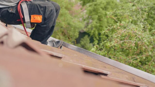 Extremely dangerous work on rooftop to prepare for solar panel installation