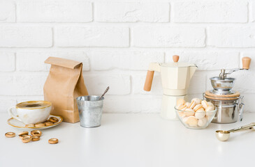 Fototapeta na wymiar Coffee preparation accessories, sweets and kitchen utensils on white table