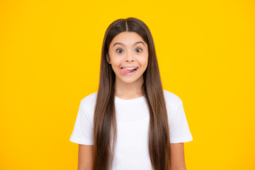 Funny kids face. Portrait of silly teenager child girl smiling and showing tongue in camera making funny faces. - obrazy, fototapety, plakaty