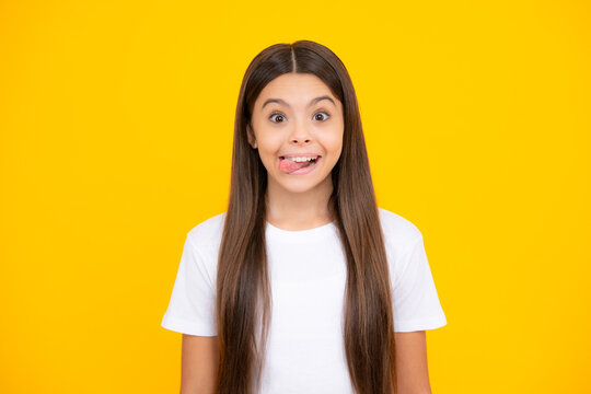 Funny kids face. Portrait of silly teenager child girl smiling and showing tongue in camera making funny faces.