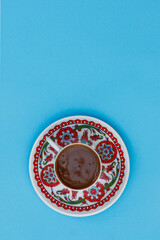 cup of traditional Turkish coffee on the blue backround
