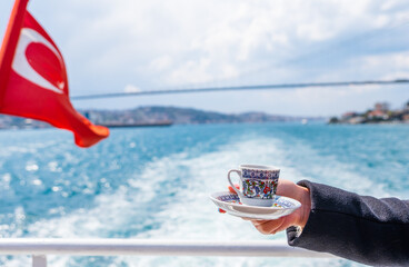 hand with turkish coffee cup and flag. Travel concept