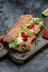 Papier Peint photo Lavable Snack Sandwiches with homemade ciabatta bread, salted salmon fish, parmesan cheese, capers, cherry tomatoes and arugula, Restaurant menu, dieting, cookbook recipe top view