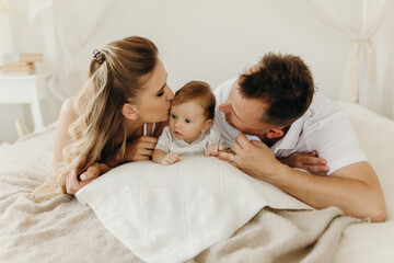 family having fun in bed together, happy family having fun in bed, portrait happy family.