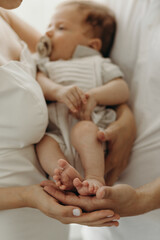Obraz na płótnie Canvas parent holding baby, happy family portrait, happy family concept