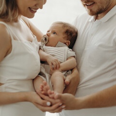 parent holding baby, 
happy family portrait, happy family concept