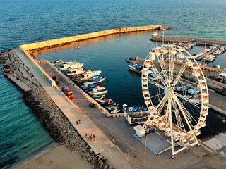 Campomarino di Maruggio con la ruota panoramica vista dal drone, al tramonto - Salento, Puglia,...