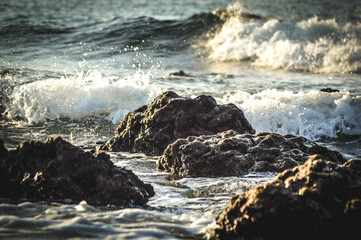 Cinematic View Sea Water Waves On Chunks Of Rocks Of Tropical Beach Village In The Afternoon