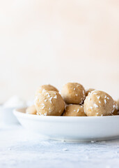 Chickpea and peanut butter candies with coconut chips. Energy balls. Healthy raw dessert without sugar. Vegan truffles.