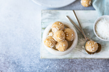Chickpea and peanut butter candies with coconut chips. Energy balls. Healthy raw dessert without sugar. Vegan truffles.
