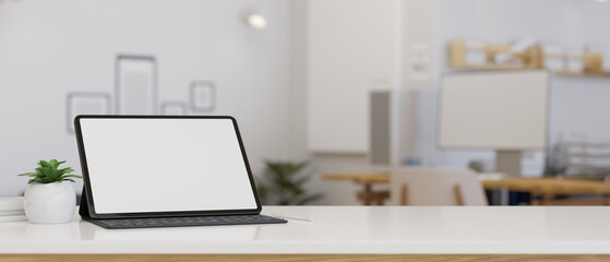 Modern tabletop workspace with portable tablet touchpad mockup over blurred office background