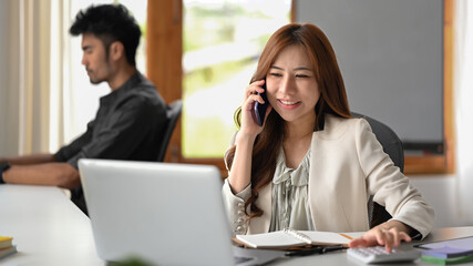 Attractive female financial advisor having negotiations, giving professional consultation to customer