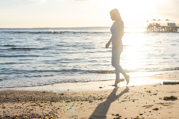 young attractive happy woman enjoys by the sea.