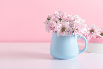 Pink flowers in blue cup against  pink wall. Valentine's Day, Happy Woman's Day, Mother's Day, Birthday, Wedding