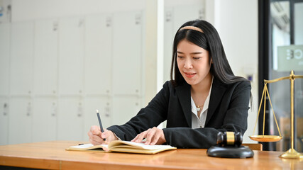 Professional Asian female business legal consultant or lawyer at her office desk