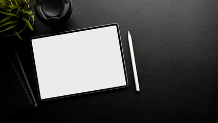 Modern black workspace top view with digital tablet mockup, stylus pen, and copy space. top view